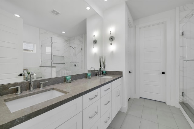 bathroom with tile patterned floors, vanity, and an enclosed shower