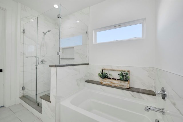 bathroom with tile patterned flooring and independent shower and bath