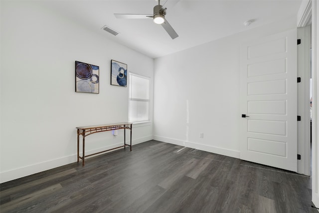 spare room featuring dark hardwood / wood-style floors and ceiling fan