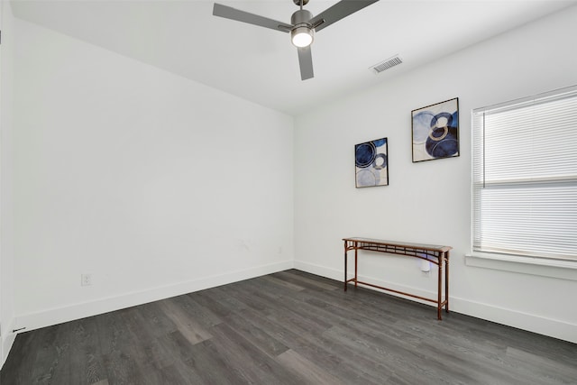 empty room with ceiling fan and dark wood-type flooring