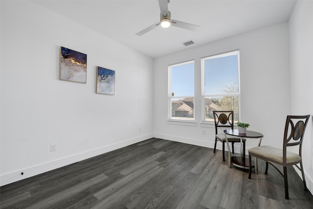 living area with ceiling fan and dark wood-type flooring