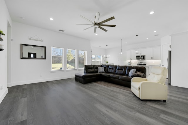 living room with ceiling fan, wood-type flooring, and sink