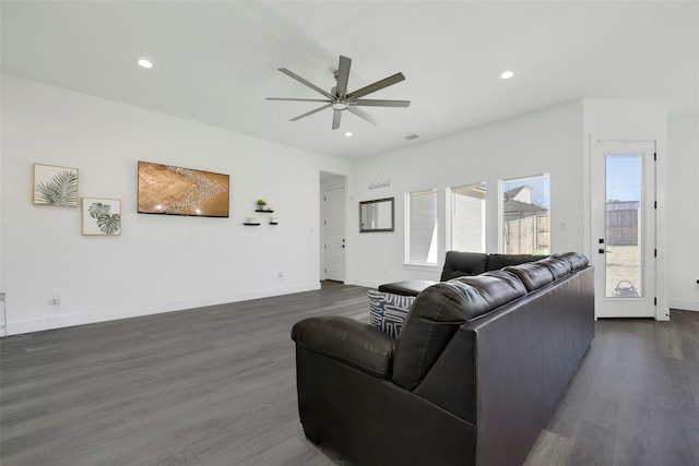 living room featuring ceiling fan and dark wood-type flooring