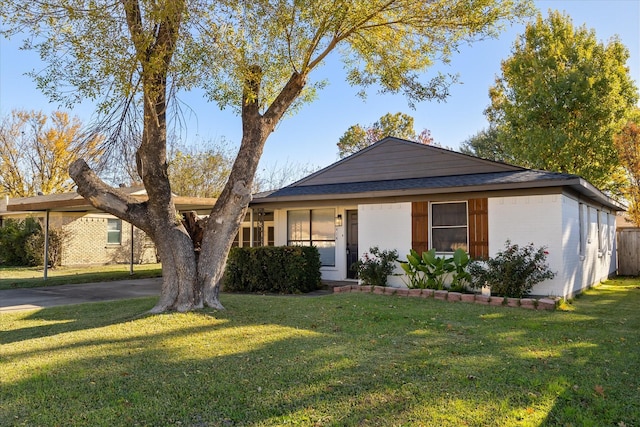 ranch-style house featuring a front yard and a carport