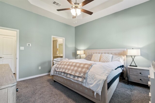 carpeted bedroom featuring ceiling fan and ensuite bathroom