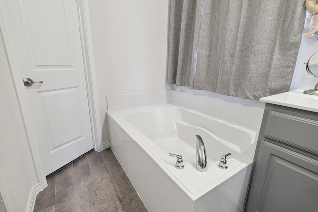 bathroom featuring a bathtub, hardwood / wood-style floors, and vanity