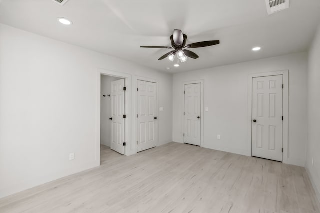 unfurnished bedroom with ceiling fan and light hardwood / wood-style flooring