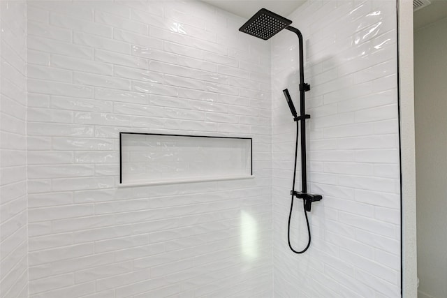 interior details featuring tiled shower