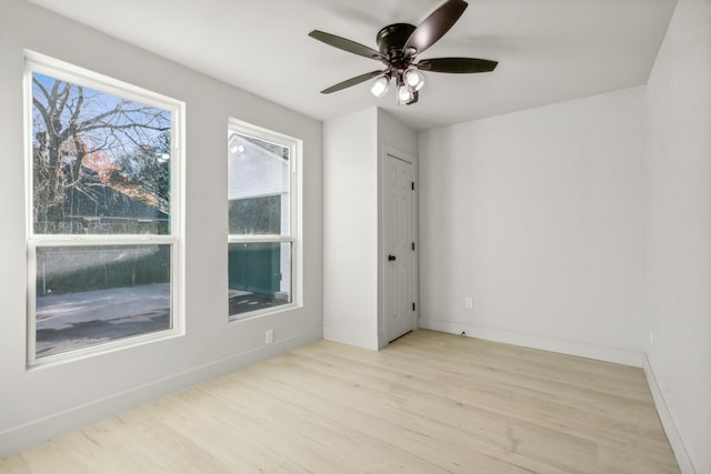 unfurnished room featuring ceiling fan and light wood-type flooring