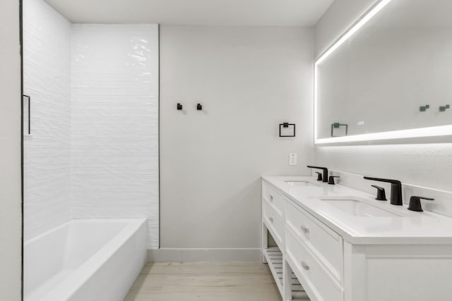 bathroom with vanity, wood-type flooring, and bathtub / shower combination