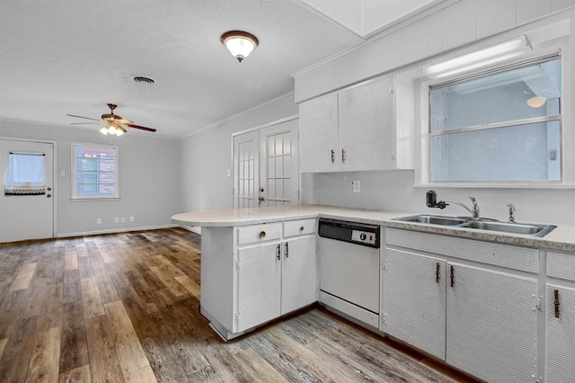 kitchen with kitchen peninsula, sink, light hardwood / wood-style flooring, dishwasher, and white cabinetry