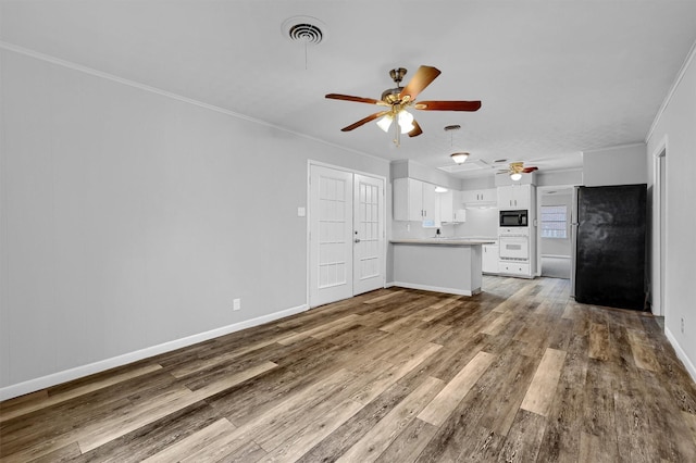 unfurnished living room with crown molding, hardwood / wood-style floors, and ceiling fan