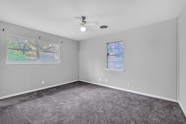 carpeted spare room with ceiling fan