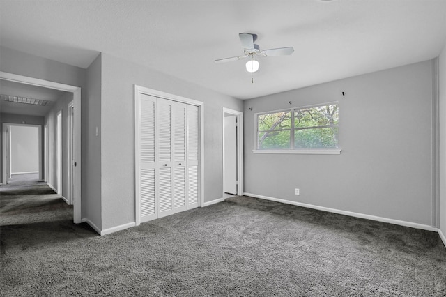 unfurnished bedroom featuring ceiling fan and dark carpet