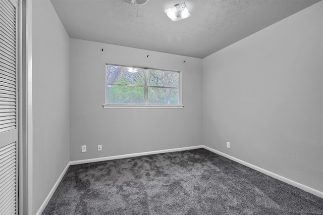 unfurnished bedroom featuring carpet floors and a textured ceiling