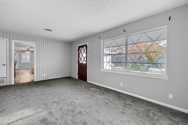 foyer entrance featuring carpet flooring, a textured ceiling, and ceiling fan