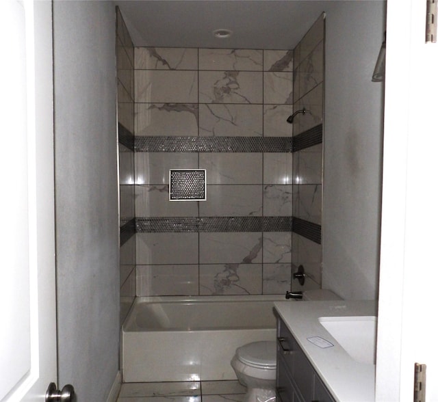 full bathroom with tiled shower / bath combo, vanity, and toilet