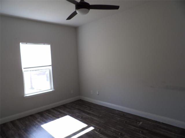 spare room with dark hardwood / wood-style flooring and ceiling fan