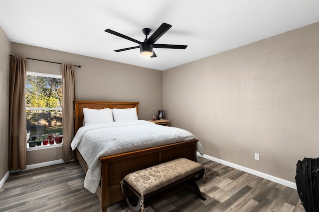 bedroom with ceiling fan and dark hardwood / wood-style floors