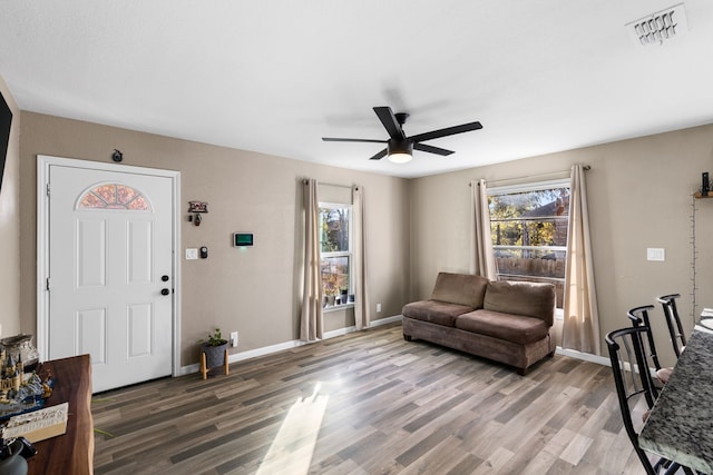 living room with hardwood / wood-style flooring, a wealth of natural light, and ceiling fan