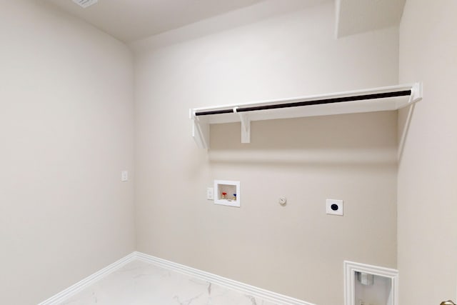 5000 Greenbrook Rd, Denton, TX 76226 - laundry area featuring hookup for a gas dryer, hookup for an electric dryer, hookup for a washing machine, light marble finish floors, and baseboards
