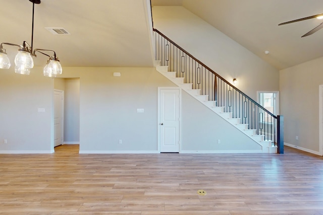 5000 Greenbrook Rd, Denton, TX 76226 - unfurnished living room featuring stairway, ceiling fan, light wood finished floors, high vaulted ceiling, and baseboards