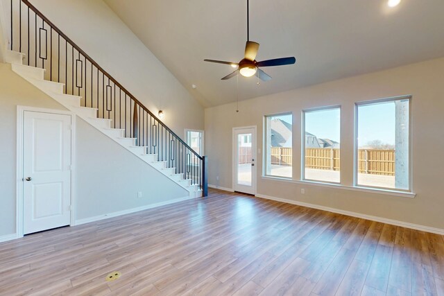 5000 Greenbrook Rd, Denton, TX 76226 - unfurnished living room featuring stairs, high vaulted ceiling, plenty of natural light, light wood-style floors, and ceiling fan