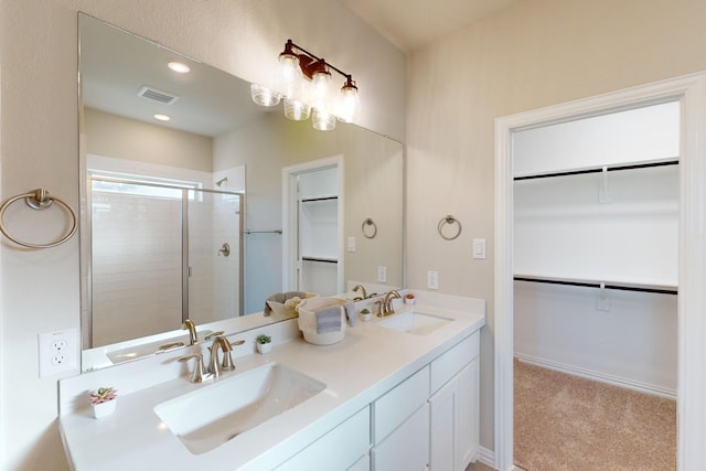 5000 Greenbrook Rd, Denton, TX 76226 - bathroom featuring a stall shower, double vanity, a spacious closet, and recessed lighting