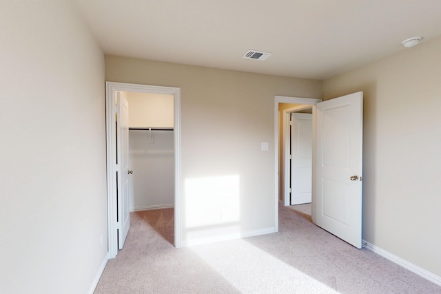 5000 Greenbrook Rd, Denton, TX 76226 - unfurnished bedroom featuring light carpet, a walk in closet, baseboards, and a closet