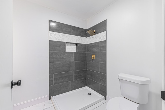 bathroom featuring toilet and tiled shower