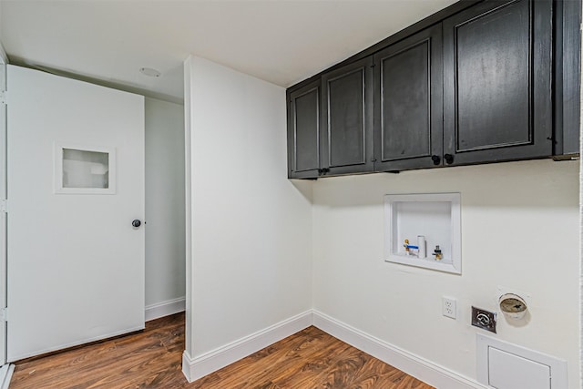 washroom featuring hookup for an electric dryer, dark hardwood / wood-style flooring, cabinets, and washer hookup