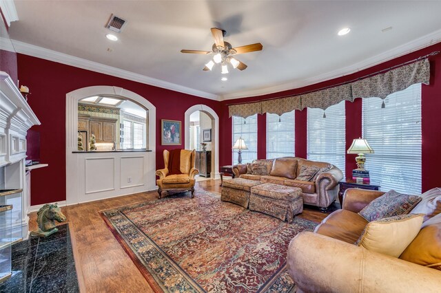 living room with ornamental molding, a healthy amount of sunlight, and hardwood / wood-style floors