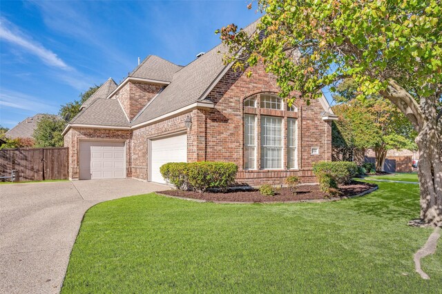 view of front facade featuring a front lawn and a garage