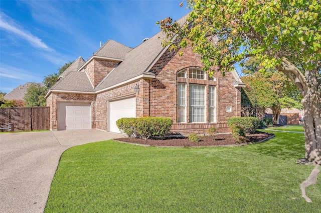 view of front facade with a garage and a front lawn