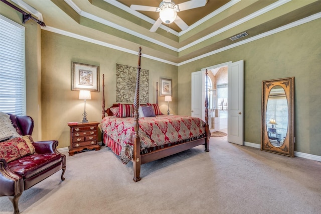 bedroom featuring ensuite bathroom, ornamental molding, carpet, ceiling fan, and a tray ceiling