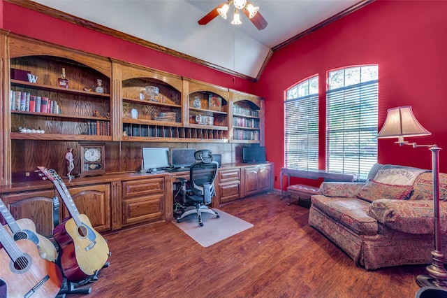 home office featuring built in desk, lofted ceiling, ceiling fan, crown molding, and dark wood-type flooring