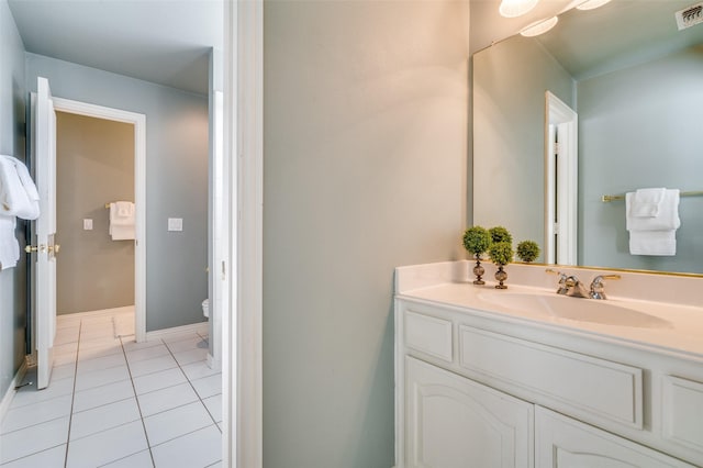 bathroom with vanity, tile patterned floors, and toilet