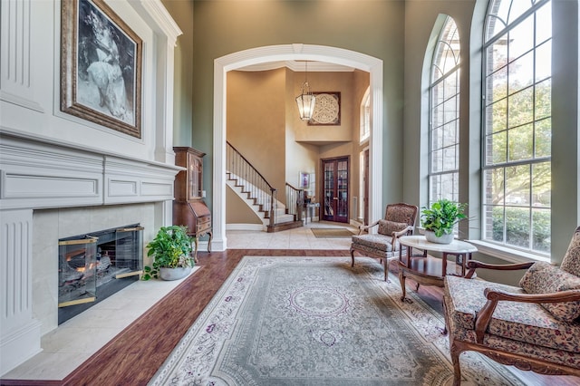 interior space featuring light hardwood / wood-style flooring, a fireplace, and a high ceiling