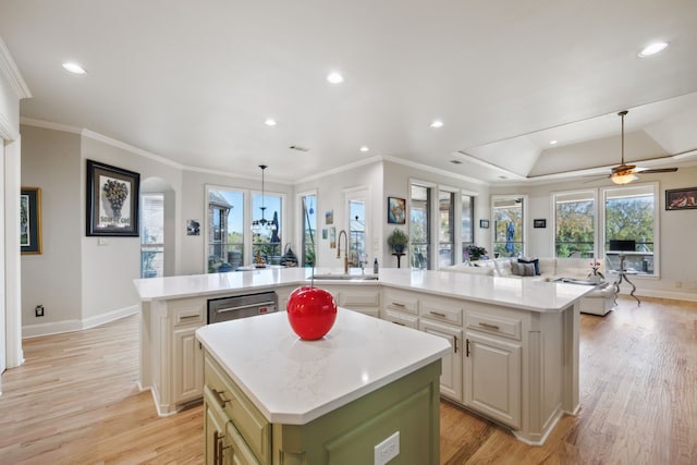 kitchen with ceiling fan, a kitchen island, light hardwood / wood-style floors, and sink