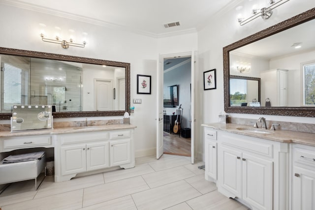 bathroom featuring tile patterned floors, vanity, a shower with door, and crown molding