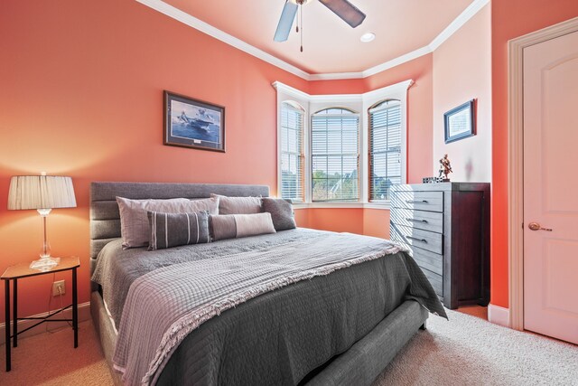 bedroom with ceiling fan, light colored carpet, and ornamental molding