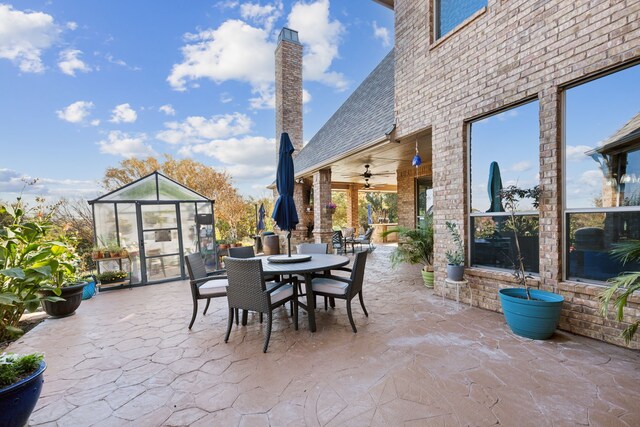 view of patio featuring an outdoor living space with a fireplace and ceiling fan