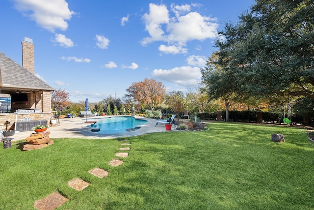 view of swimming pool featuring a yard and a patio