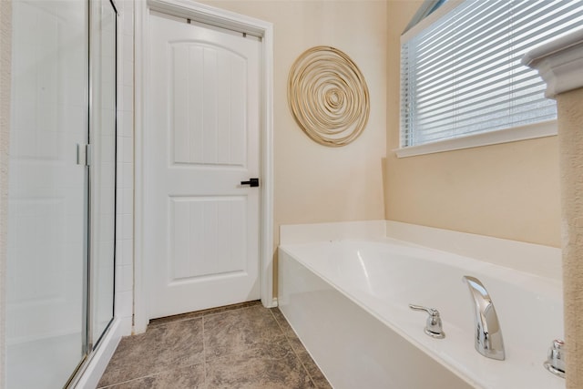 bathroom featuring tile patterned floors and separate shower and tub