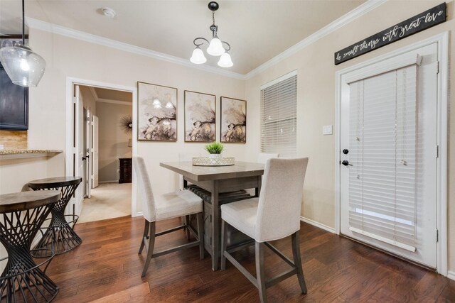 dining area with hardwood / wood-style floors, a high ceiling, and an inviting chandelier