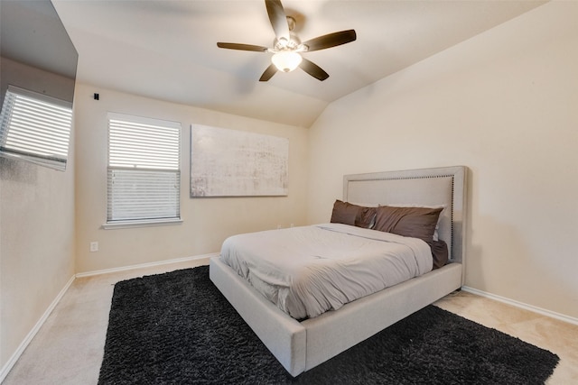 bedroom with ceiling fan, light colored carpet, and lofted ceiling