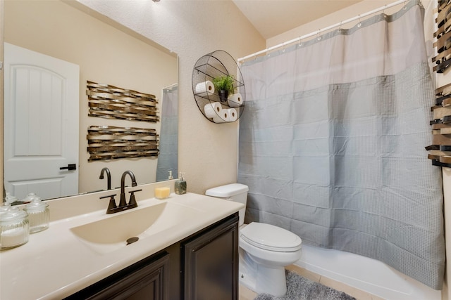 bathroom featuring tile patterned flooring, vanity, curtained shower, and toilet