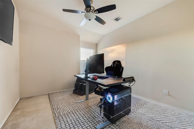 carpeted office with ceiling fan and vaulted ceiling