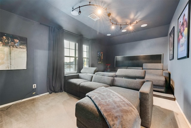 carpeted bedroom with rail lighting