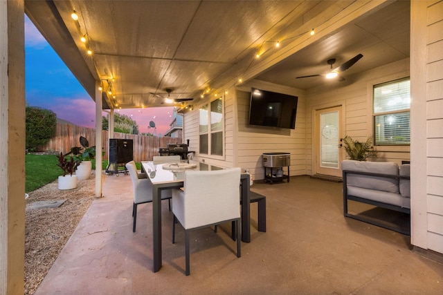 patio terrace at dusk featuring ceiling fan